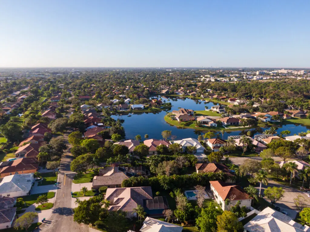Aerial view of Florida, showcasing residential neighborhoods near a lake; ideal for Expert Tile & Flooring services.