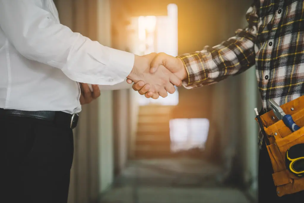Handshake between a customer and a contractor, symbolizing Expert Tile & Flooring Tile Installation in South Florida.