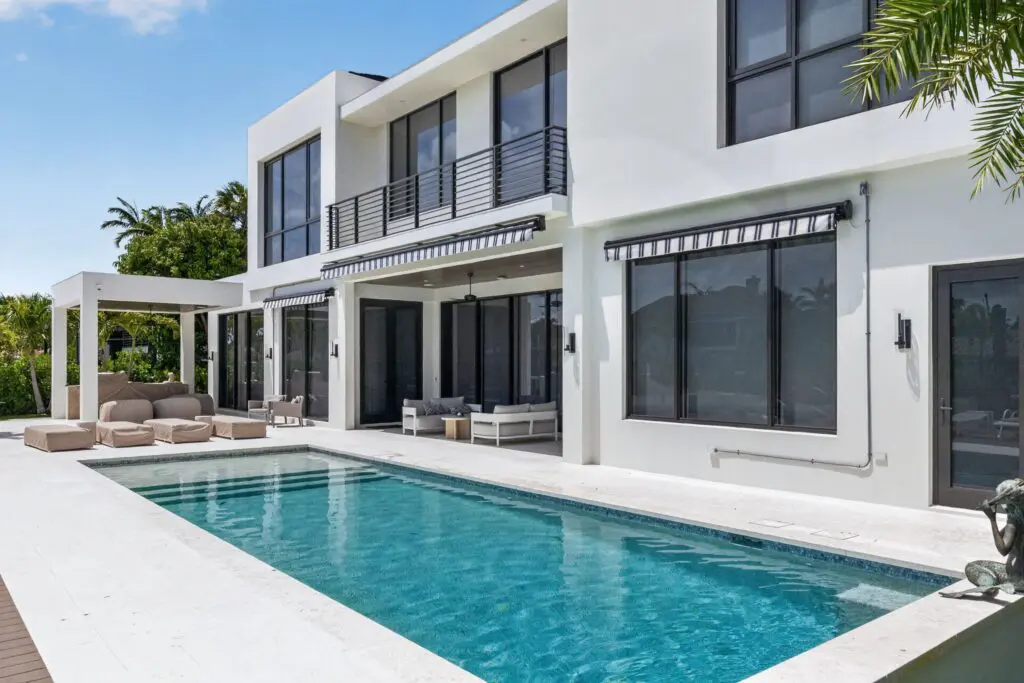 Modern home with expertly installed tile flooring and a sleek pool, showcasing Expert Tile & Flooring's work in South Florida.
