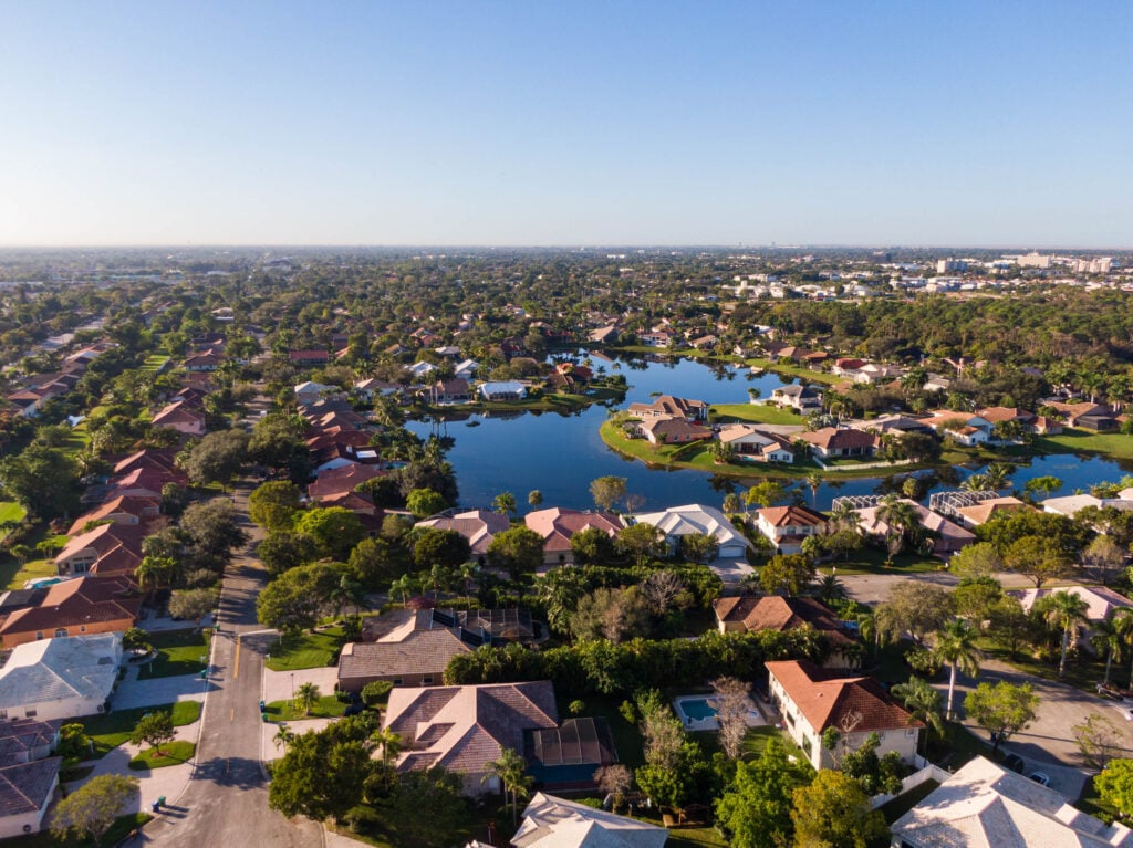 Aerial view of Florida, showcasing residential neighborhoods near a lake; ideal for Expert Tile & Flooring services.